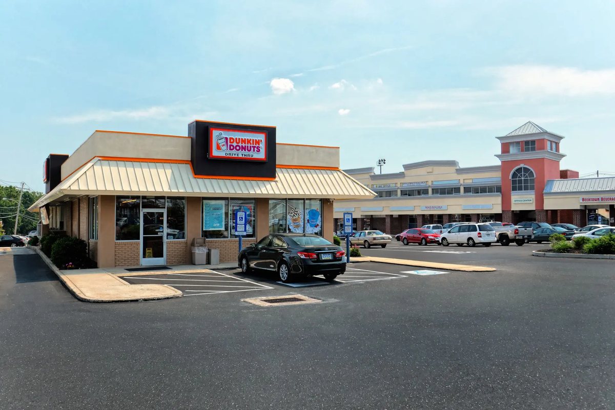 Dunkin' drive-thru pad with the two-story office building beyond